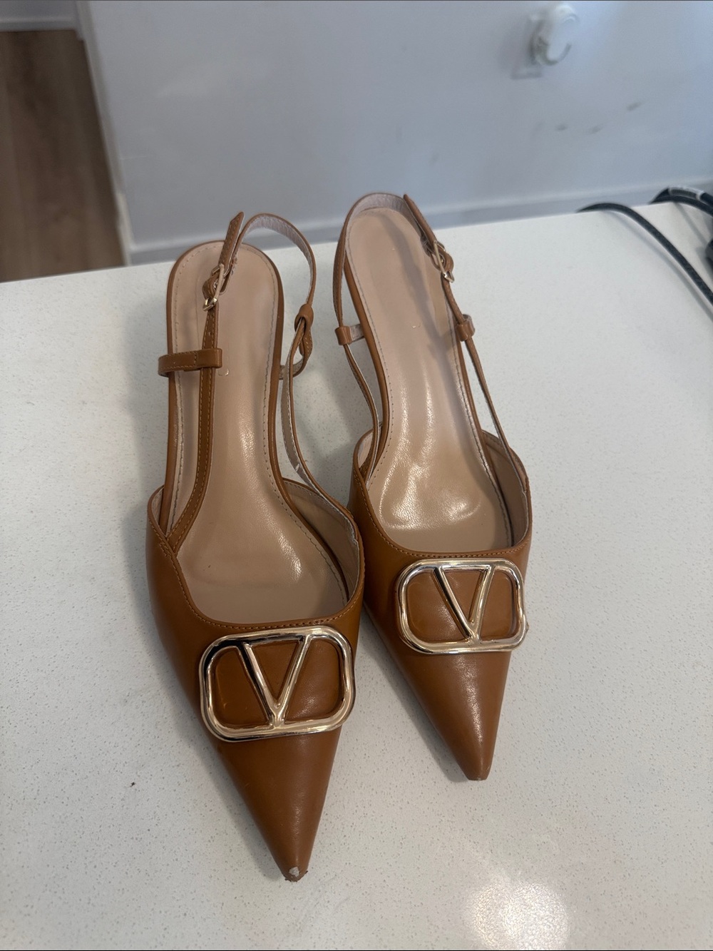 Pointed Tan Slingback Heels with Gold V Emblem